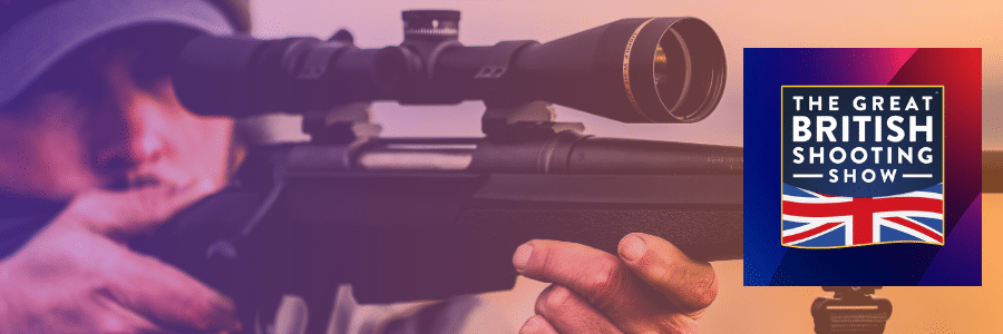 A person aiming through the scope of a rifle, set against a gradient background with the logo for 'The Great British Shooting Show' featuring a Union Jack design on the right-hand side.